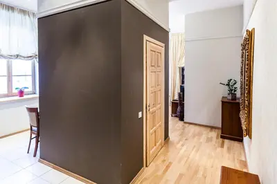 a large black door in a room with a table at Central apartments 1 x Free parking x Self Check in in Vilnius