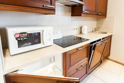 a small kitchen with a microwave on a counter at Central apartments 1 x Free parking x Self Check in in Vilnius