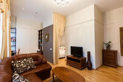 a living room with a couch and a television at Central apartments 1 x Free parking x Self Check in in Vilnius