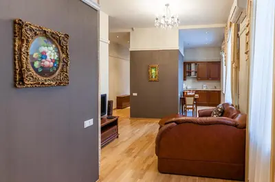 a living room with a couch and a painting on the wall at Central apartments 1 x Free parking x Self Check in in Vilnius
