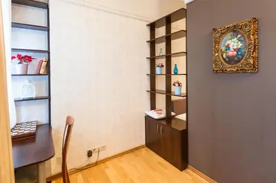 a room with a wall with shelves and a table at Central apartments 1 x Free parking x Self Check in in Vilnius