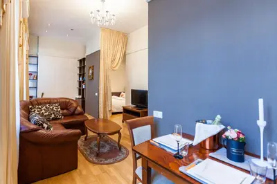 a living room with a couch and a table at Central apartments 1 x Free parking x Self Check in in Vilnius