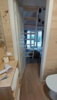 a tiny house with a ladder in a room at Apgyvendinimas Rokiskyje namukas Skandis in Rokiškis
