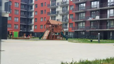 a playground in front of a large apartment building at Brand New! 2Bdr 70m2 Old Town in Vilnius