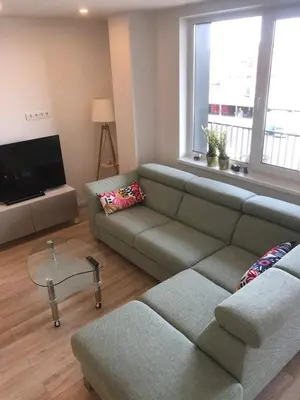 a living room with a couch and a flat screen tv at Brand New! 2Bdr 70m2 Old Town in Vilnius