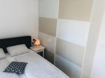 a bedroom with two beds and a table with a lamp at Brand New! 2Bdr 70m2 Old Town in Vilnius