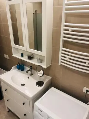 a bathroom with a white sink and a mirror at Brand New! 2Bdr 70m2 Old Town in Vilnius