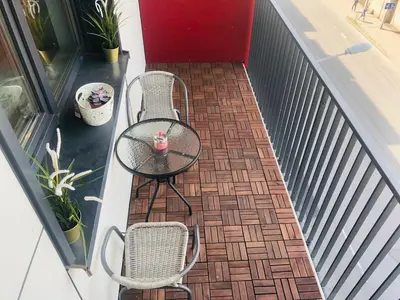 a patio with a table and chairs on a balcony at Brand New! 2Bdr 70m2 Old Town in Vilnius