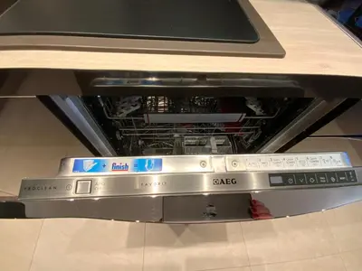 an open dishwasher with a stove top at West Side Druskininkai in Druskininkai