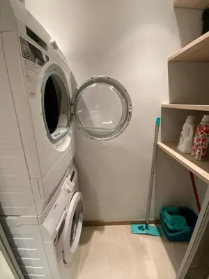 a washing machine in a laundry room with a mirror at West Side Druskininkai in Druskininkai