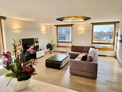a living room with a couch and a tv at West Side Druskininkai in Druskininkai