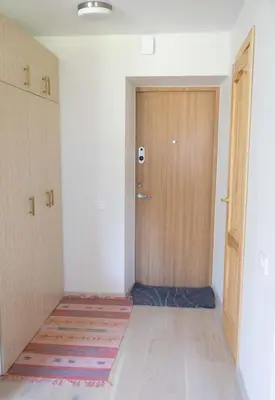 an empty room with a door and a rug at Močiutės apartamentai in Anykščiai