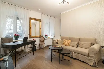 a living room with a couch and a table at Old Town Apartment on quiet private street in Vilnius