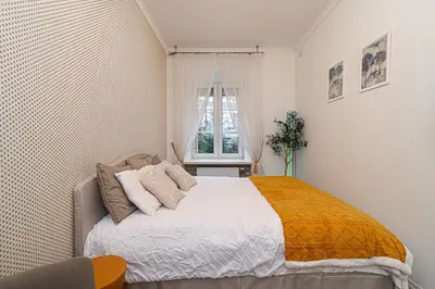 a bedroom with a large bed in a room at Old Town Apartment on quiet private street in Vilnius