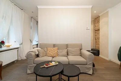 a living room with a couch and a table at Old Town Apartment on quiet private street in Vilnius