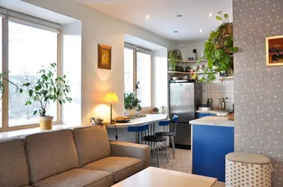 a living room with a couch and a kitchen at Lovely room in a centrally located flat in Vilnius