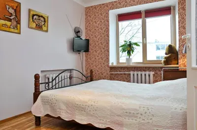 a bedroom with a bed and a window at Lovely room in a centrally located flat in Vilnius