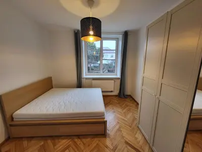 a bedroom with a bed and a window at Treniotos Apartamentai in Vilnius