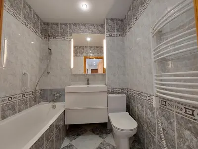 a bathroom with a toilet and a tub and a sink at Treniotos Apartamentai in Vilnius