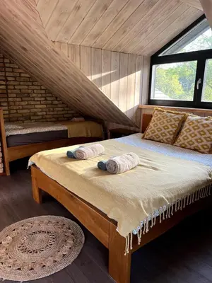 a bedroom with a bed with two pillows on it at Kaimukas - lake house for 15 persons 5 bedrooms in Dvarčėnai