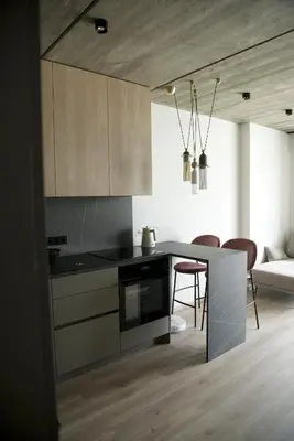 a kitchen with a table and chairs in a room at Ralio apartamentai monkey in Vilnius