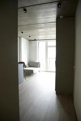 an open door to a living room with a couch at Ralio apartamentai monkey in Vilnius