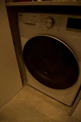 a white microwave oven sitting on a kitchen floor at Ralio apartamentai monkey in Vilnius