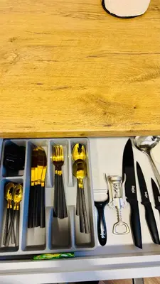 a tray of utensils sitting on a counter at Light of Happiness in Anykščiai
