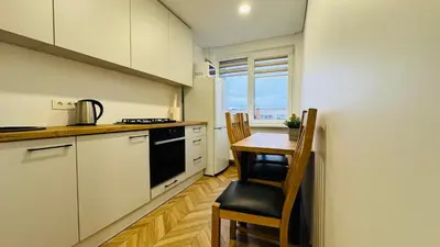 a kitchen with a table and chairs and a window at Light of Happiness in Anykščiai