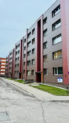 an empty street in front of a large building at Light of Happiness in Anykščiai