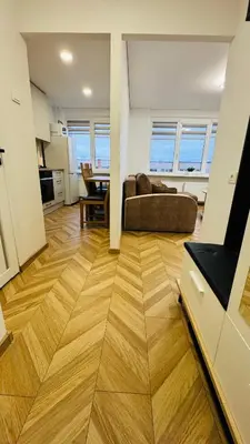a living room with a couch and a table at Light of Happiness in Anykščiai