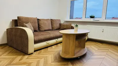 a living room with a couch and a table at Light of Happiness in Anykščiai