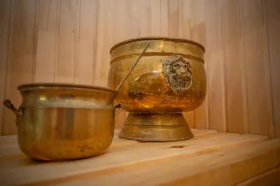 two old vases sitting on a wooden shelf at Poilsio oazė in Panevėžys