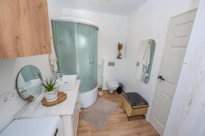 a bathroom with a glass shower and a toilet at Poilsio oazė in Panevėžys