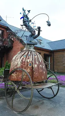a statue of a woman sitting on a cart at Gallery Guest Rooms in Kernavė