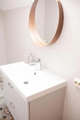 a bathroom with a sink and a mirror on the wall at Pakaso sodyba, šiaurinė pusė in Kirdeikiai