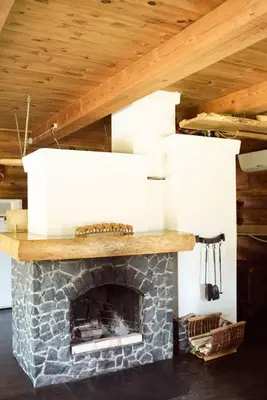 a fireplace with two white boxes on top of it at Pakaso sodyba, šiaurinė pusė in Kirdeikiai