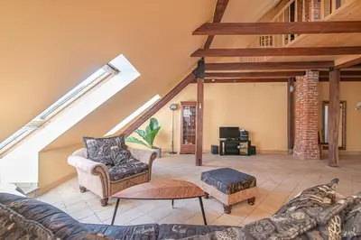 a living room with a couch and a table at Apartment with Sauna in Vilnius