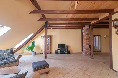 a living room with a couch and a brick wall at Apartment with Sauna in Vilnius