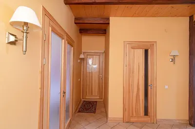 a hallway with a wooden ceiling and a door at Apartment with Sauna in Vilnius