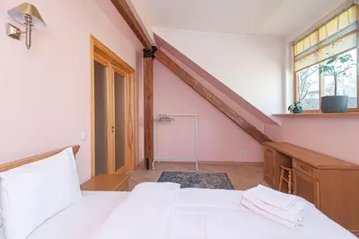 a bedroom with a white bed and a window at Apartment with Sauna in Vilnius