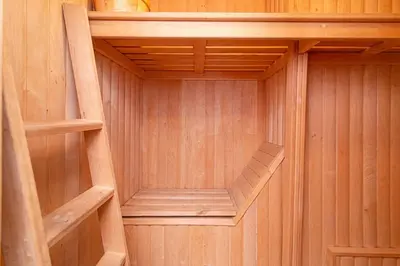 a wooden sauna with a wooden stairs in it at Apartment with Sauna in Vilnius