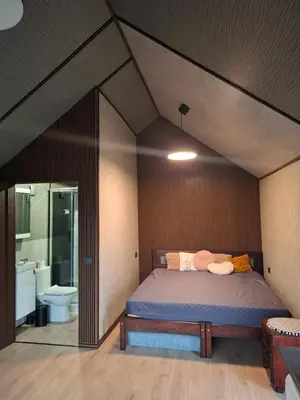 a bedroom with a bed and a bathroom at TORA nameliai in Aukštadvaris
