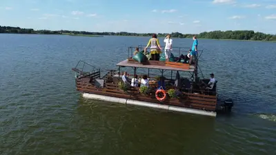 a group of people on a boat in the water at TORA nameliai in Aukštadvaris