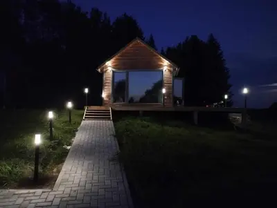 a small building with lights on it at night at TORA nameliai in Aukštadvaris