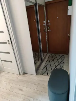 a room with a blue stool and a door at Butas miesto centre in Šiauliai