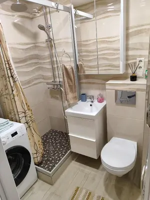a small bathroom with a washing machine and a sink at Butas miesto centre in Šiauliai