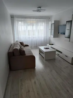 a living room with a couch and a coffee table at Butas miesto centre in Šiauliai