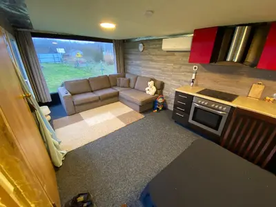 a small living room with a couch and a kitchen at Karalgirio žvejų namelis in Karalgiris