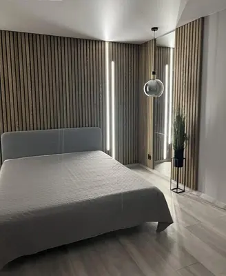 a bedroom with a bed and a potted plant at LUX Apartamentai in Marijampolė
